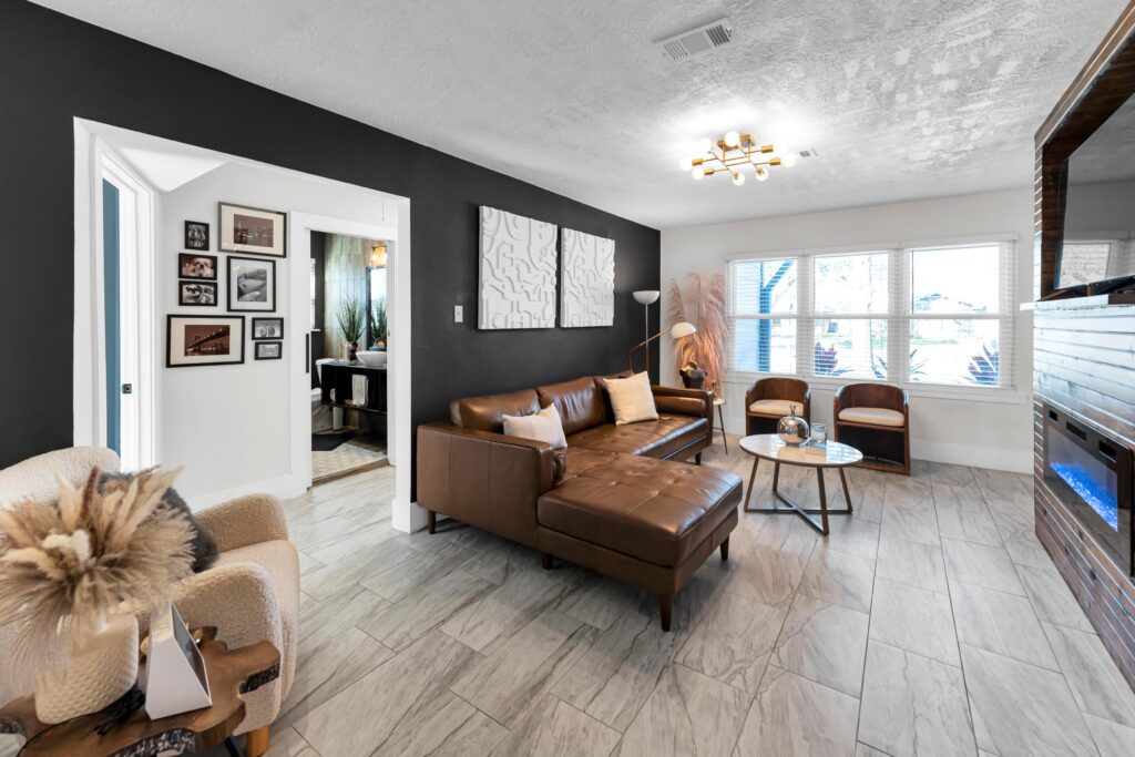 house living room after remodel with tile floor and black and white walls 4